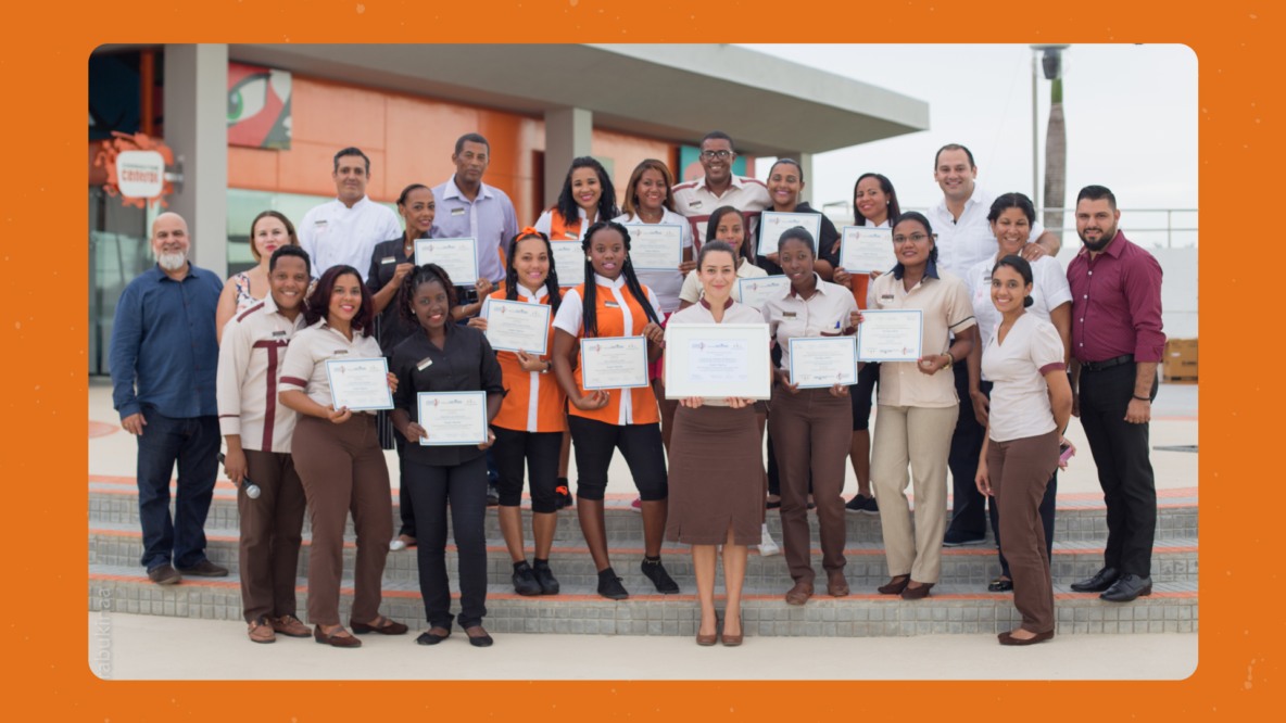Graduates of the Nickelodeon Hotels training program with certificates at the awards ceremony